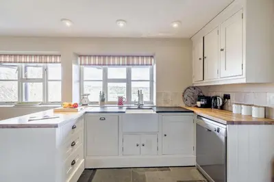 a kitchen with white cabinets and a sink at 4 Bed in Builth Wells oc-bow197 in Builth Wells