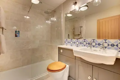a bathroom with a toilet and a sink and a tub at 2 Bed in Builth Wells oc-bow198 in Builth Wells