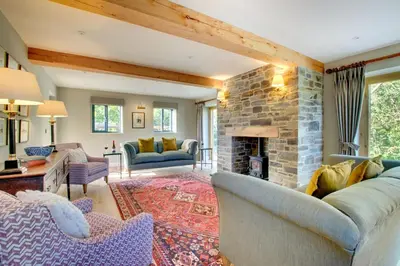 a living room with a couch and a stone fireplace at 2 Bed in Builth Wells oc-bow198 in Builth Wells