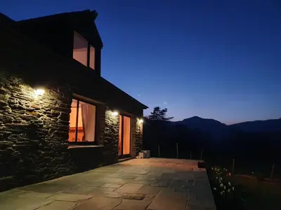 a stone house with a patio at night at 4 Bed in Ffestiniog oc-bow172 in Ffestiniog