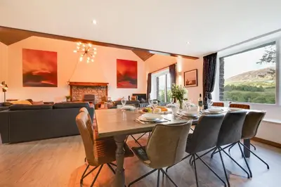 a dining room and living room with a table and chairs at 4 Bed in Ffestiniog oc-bow172 in Ffestiniog