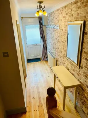a room with a table and a window and a door at Gorwel, Spacious 3 Bedroom Cottage near the Beach in Llanarth